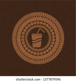 soda icon inside badge with wood background