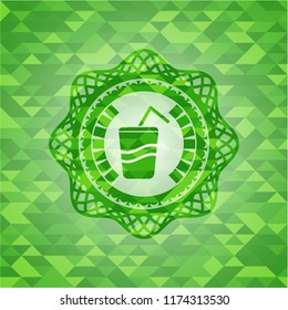 soda icon inside green emblem. Mosaic background