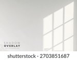 Soft sunlight streams through a window frame, casting quiet, dreamy shadows on a white wall, reminding us of slow, peaceful mornings