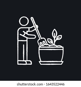 Soil fluffing chalk white icon on black background. Plowing, ploughing earth. Houseplant care. Aeration. Plant growing, planting process. Indoor gardening. Isolated vector chalkboard illustration