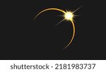 A solar eclipse with a glare from the appearing sun.