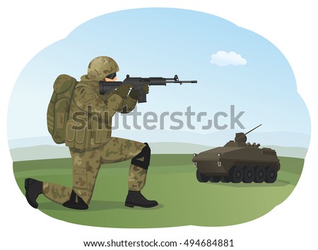 Soldier in uniform is standing on one knee and ready to fight. Shooting training. Armored troop carrier on the background.