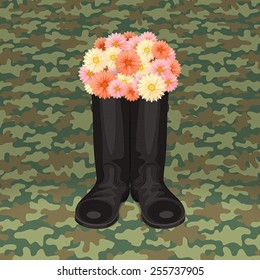 Soldier's boots with bouquet of flowers, on green camouflage background