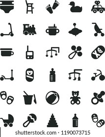 solid black flat icon set toys over the cradle vector, cot, dummy, mug for feeding, bottle, measuring, diaper, beanbag, baby rattle, stroller, summer, rubber duck, bath ball, stacking toy, tumbler