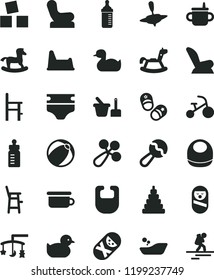 solid black flat icon set toys over the cradle vector, mug for feeding, bottle, measuring, diaper, bib, baby, beanbag, rattle, chair, car child seat, rubber duck, duckling, bath ball, stacking toy