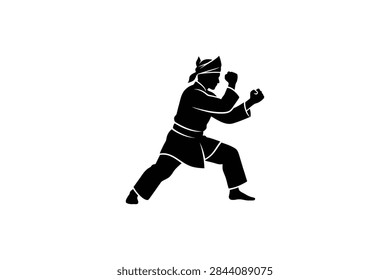 A solid black silhouette of a practitioner of Pencak Silat in a defensive stance wearing traditional Indonesian martial arts clothing and a headpiece.