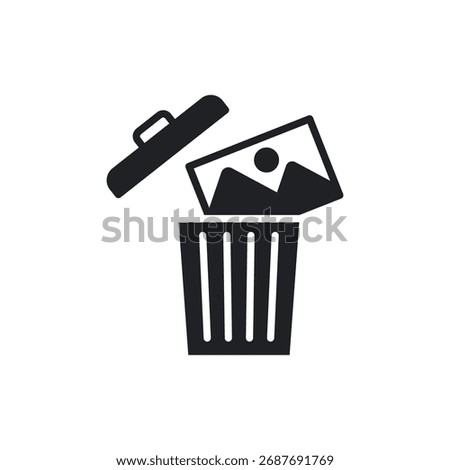 Solid icon showing a photo being removed into a trash can or basket.