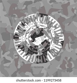 solution icon inside grey camouflaged emblem