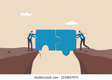 Solution or teamwork to solve problem together, cooperation or collaborate to success in work, partnership concept, business people connect jigsaw piece together to build the bridge to cross the gap.