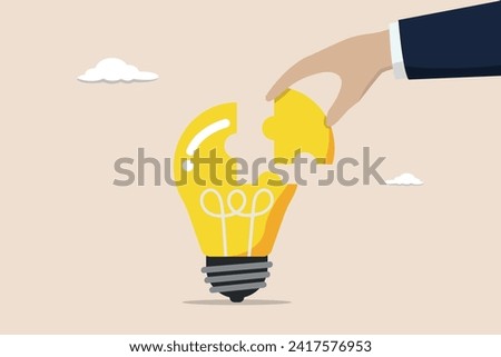 Solve business problem with creativity, complete brilliant idea, work solution or business idea concept, smart businessman assemble last piece of jigsaw to complete lightbulb idea puzzle.