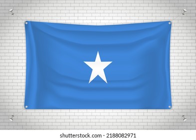 Somalia flag hanging on brick wall. 3D drawing. Flag attached to the wall. Neatly drawing in groups on separate layers for easy editing.