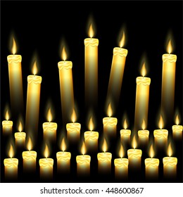 Some burning candles on black background 