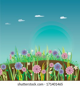 some colored flowers in the grass in a park