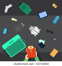 Someone packing his stuff for travel in an opened suitcase.  He puts in suitcase clothes, shoes, glasses, cosmetics,  camera and passport. Camera top view.
