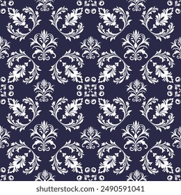 A sophisticated and elegant floral pattern featuring white ornamental designs set against a deep navy blue background. The intricate foliage and symmetrical motifs create a timeless and classic look, 