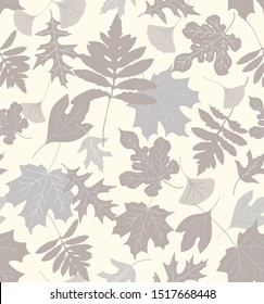 Sophisticated seamless repeat pattern with neutral tan and gray leaves silhouettes tossed on a cream background