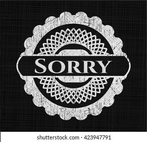 Sorry chalk emblem written on a blackboard