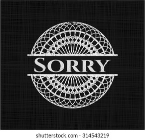 Sorry chalkboard emblem on black board