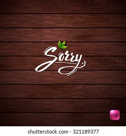Sorry concept on a wooden textured background with classic flowing white text, fresh green leaves, a vignette and pink button conceptual of an apology or sympathy, vector illustration