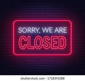 Sorry we are closed neon sign on brick wall background.