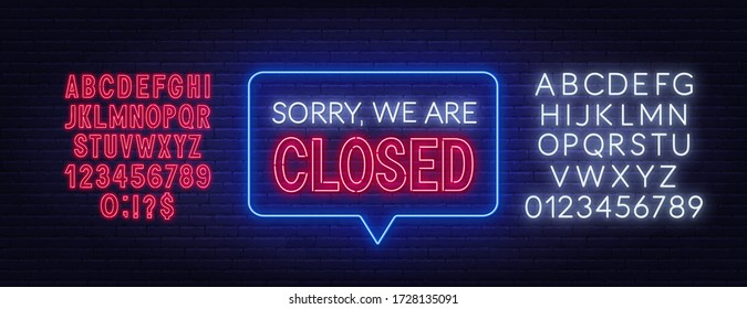 Sorry we are closed neon sign on brick wall background.