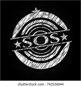 SOS written on a blackboard