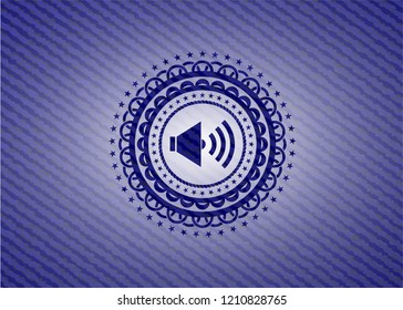sound icon inside badge with denim texture