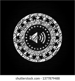 sound icon inside chalk emblem