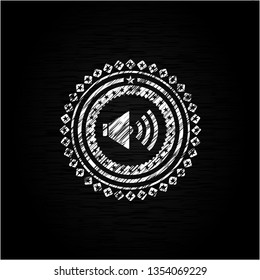 sound icon inside chalkboard emblem on black board