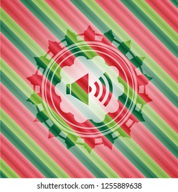 sound icon inside christmas badge background.