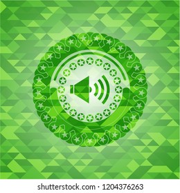 sound icon inside green emblem with mosaic background