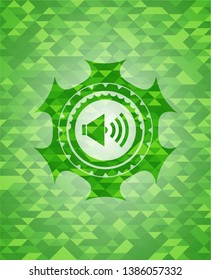 sound icon inside green emblem. Mosaic background