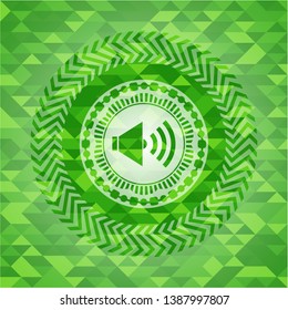 sound icon inside green emblem. Mosaic background