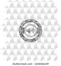 sound icon inside grey badge with geometric cube white background