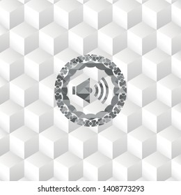 sound icon inside grey badge with geometric cube white background