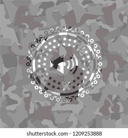sound icon inside grey camouflaged emblem