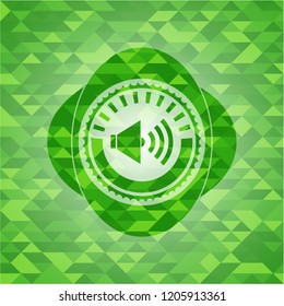 sound icon inside realistic green emblem. Mosaic background