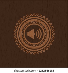 sound icon inside realistic wooden emblem