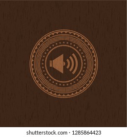 sound icon inside retro style wooden emblem