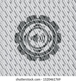 sound icon inside shiny silver emblem. Scales pattern. Vector Illustration. Detailed.
