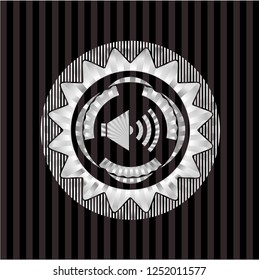 sound icon inside silver emblem or badge