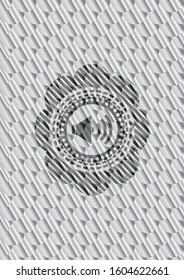 sound icon inside silver emblem or badge. Scales pattern. Vector Illustration. Detailed.