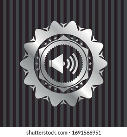 sound icon inside silver emblem. 