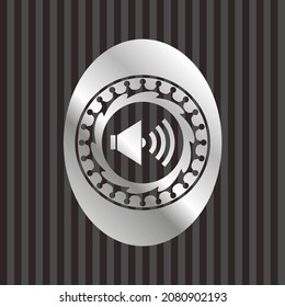 sound icon inside silvery emblem. 