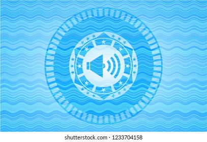sound icon inside sky blue water wave emblem background.