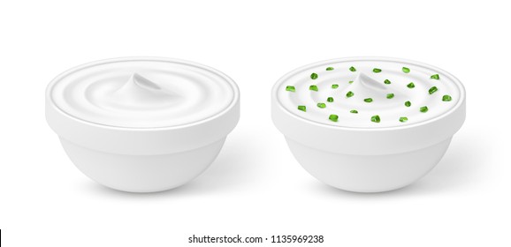 Sour cream with green onion in a bowl isolated on white background
