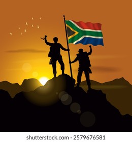 South Africa flag, silhouette of two climbers holding flags at sunset