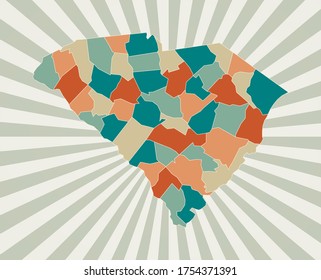 South Carolina map. Poster with map of the US state in retro color palette. Shape of South Carolina with sunburst rays background. Vector illustration.