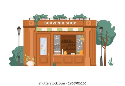Souvenir shop facade exterior isolated small retail business building flat cartoon. Vector antique store, collectables in shop window, presents, gifts, decorative vases. Green trees, street lamps