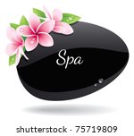 Spa background of black pebble decorated with flowers